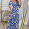 a lady wearing blue solid botanical printed long dress with drop shoulders and cut out waist design