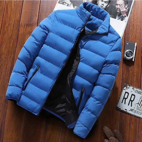 Sky blue puffer jacket with black lining displayed on a wooden background