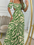 a lady wearing green solid botanical printed long dress with drop shoulders and cut out waist design