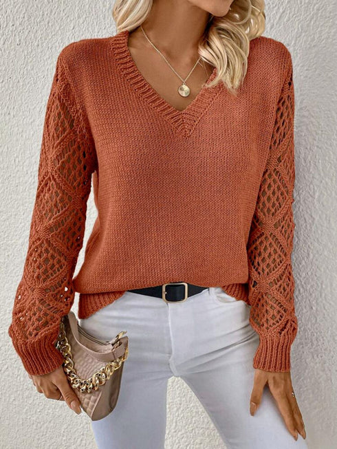 Woman wearing an orange red V-neck pullover sweaters with hollow long sleeves