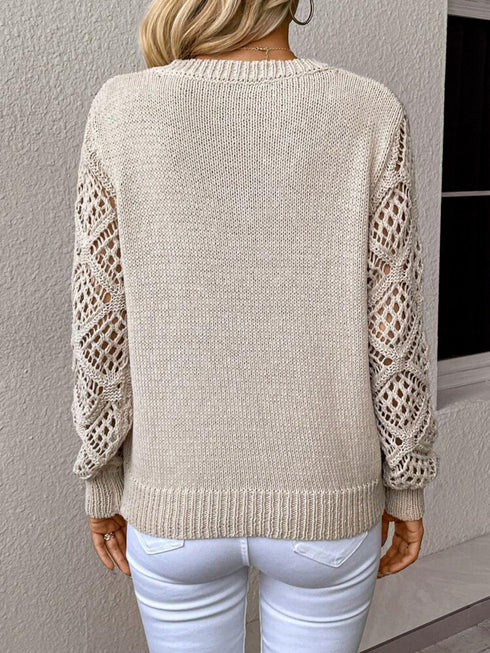 Back view of a woman wearing a V-neck pullover sweaters with hollow long sleeves