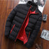 Black puffer jacket with red lining displayed on a wooden background
