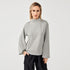 A lady wearing grey high neck sweatshirt