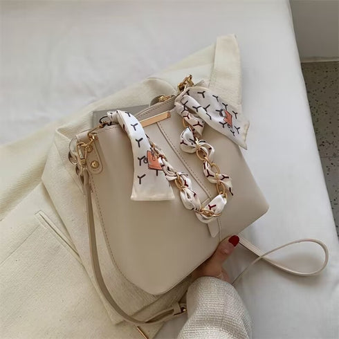 shoulder bag with chain and cloth bow in light brown colour