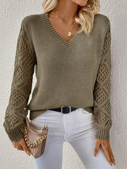 Woman wearing an army green V-neck pullover sweaters with hollow long sleeves